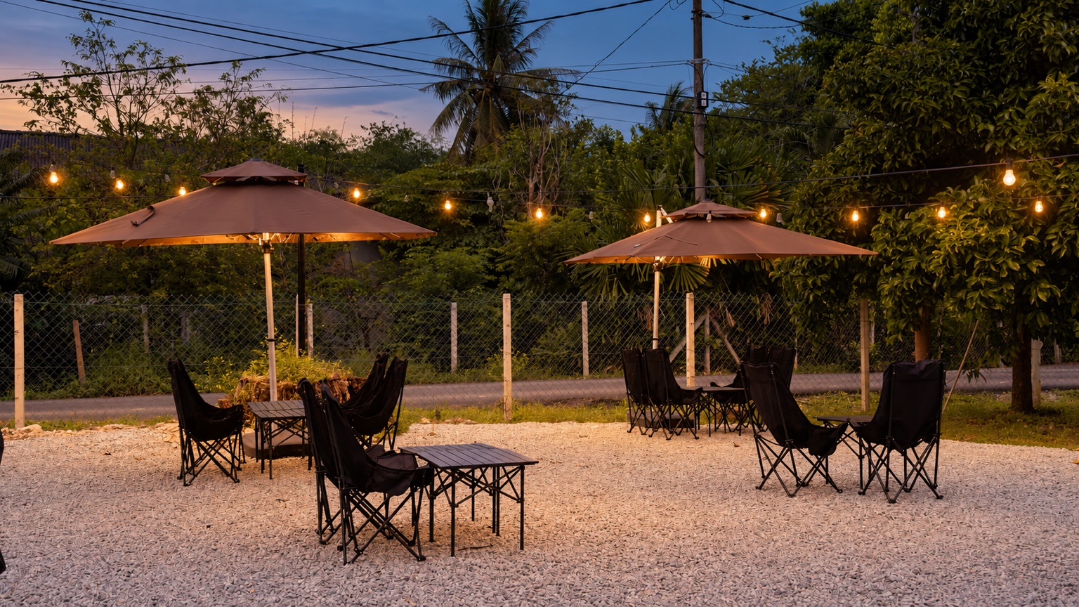 Beranda outdoor seating at dusk, with warm string lights and garden umbrellas